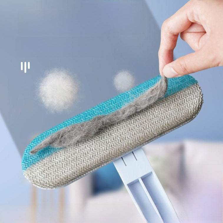 Hand holding a pet hair removal tool with collected fur against a blurred background